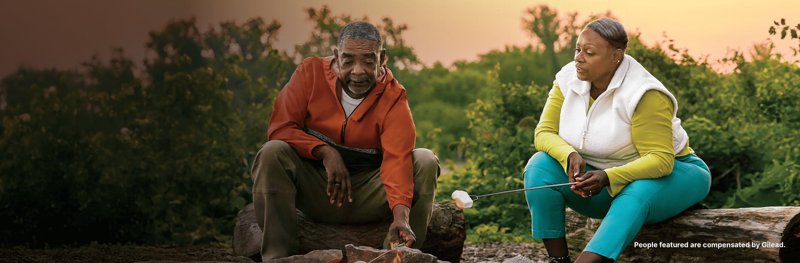 Angela, a woman with PBC, roasting marshmallows with her husband at sunset