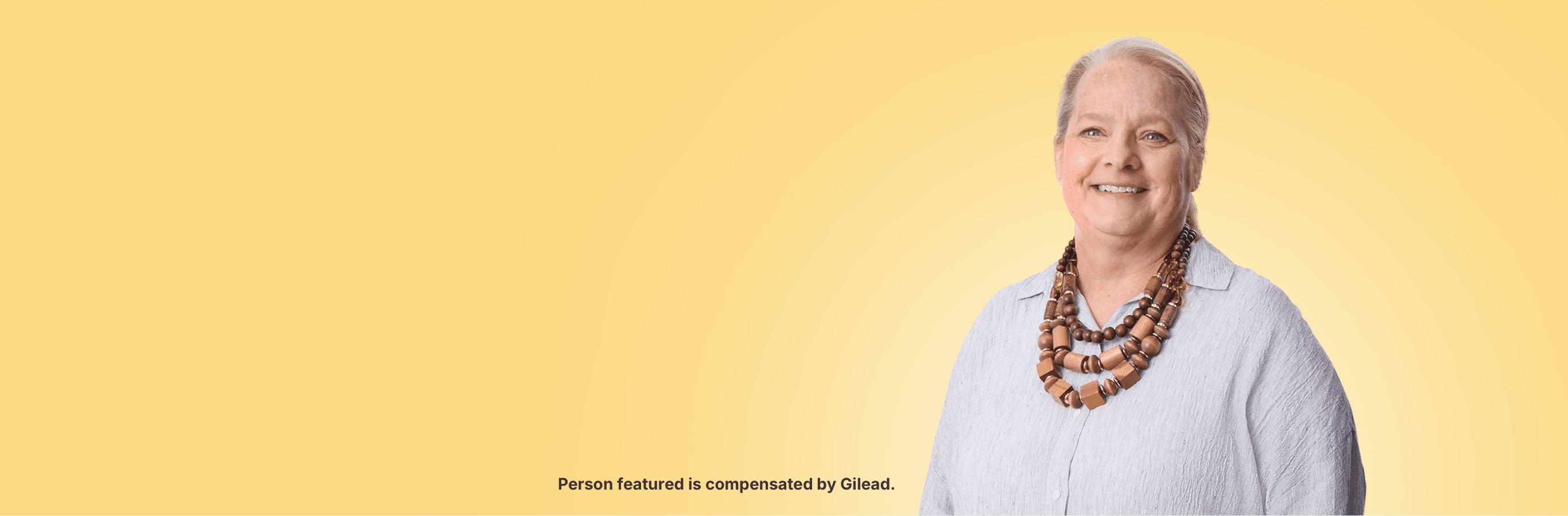 Wendy, a woman with PBC, standing in front of a cream background