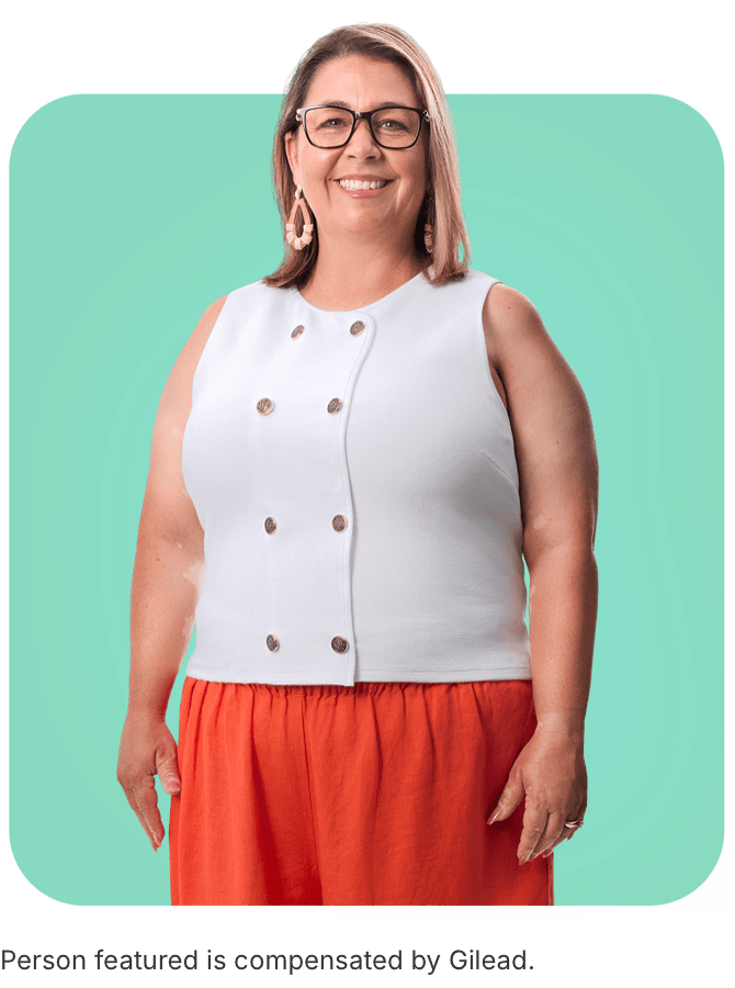 Jennifer, a woman with PBC, standing in front of a mint green background