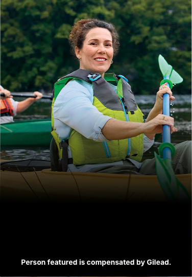 Amanda, a woman with PBC, smiling while kayaking with her husband